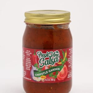 A jar of salsa with tomatoes and peppers.