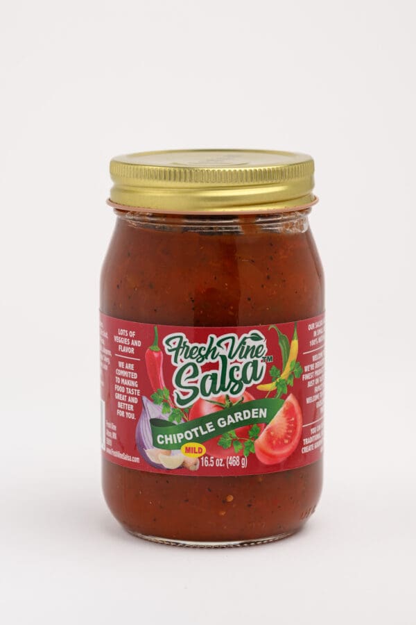 A jar of salsa with tomatoes and peppers.