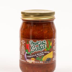 A jar of salsa with chili and other ingredients.