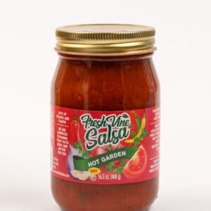 A jar of salsa with tomatoes and onions.