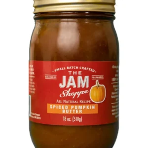 A jar of pumpkin butter with the label " the jam shoppe ".