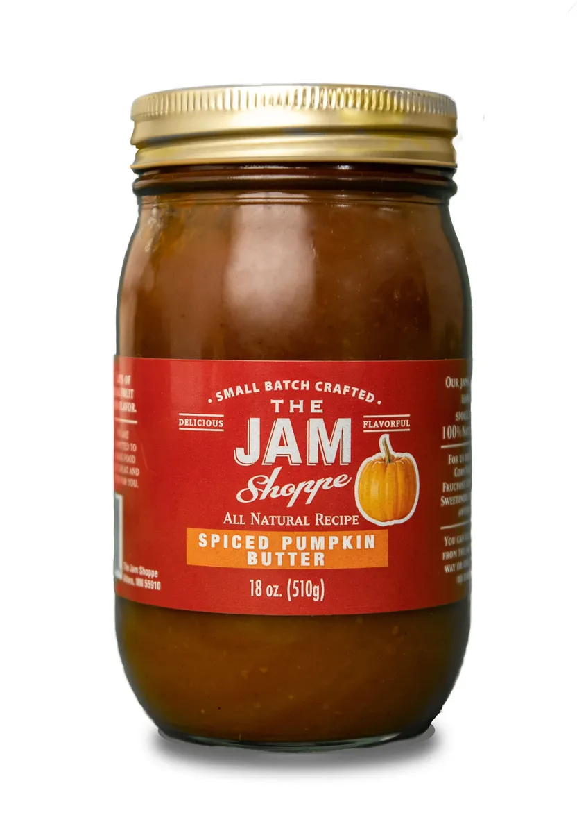 A jar of pumpkin butter with the label " the jam shoppe ".