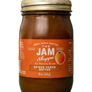 A jar of jam with the label " the jam shoppe ".