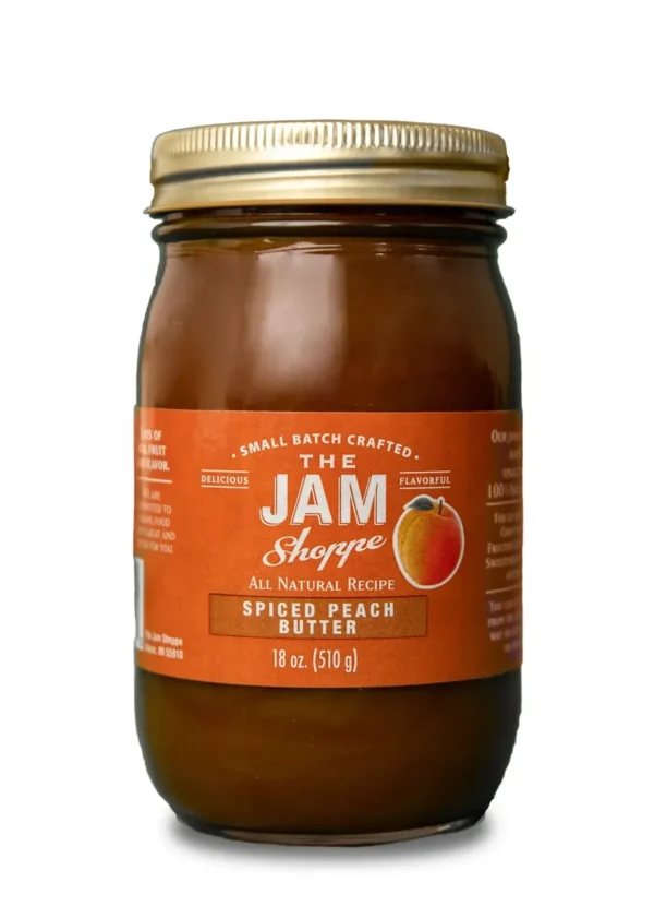 A jar of jam with the label " the jam shoppe ".