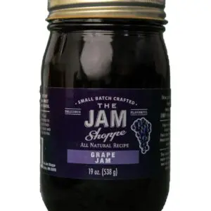 A jar of jam with purple label on it.