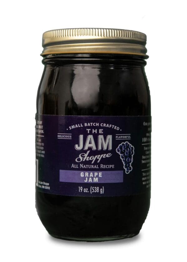 A jar of jam with purple label on it.