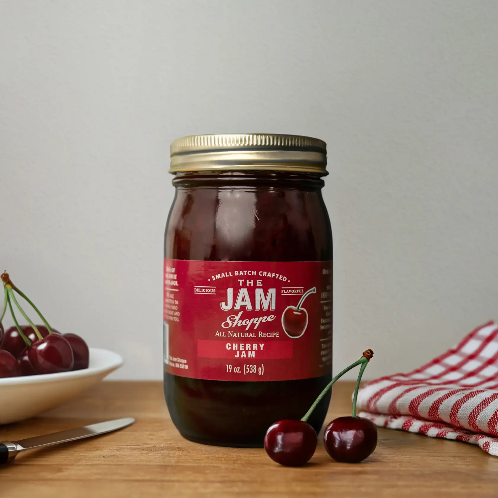 A jar of jam sitting on top of a table.