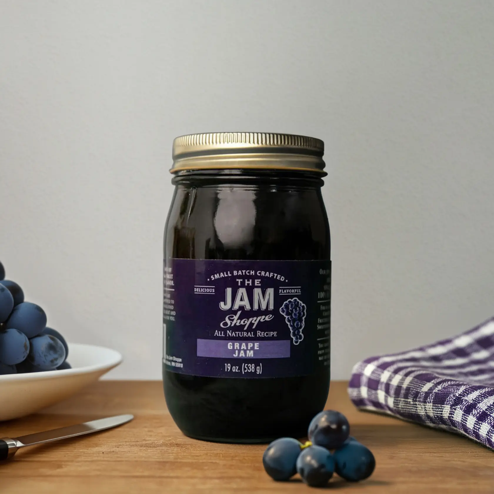 A jar of jam sitting on top of a table.