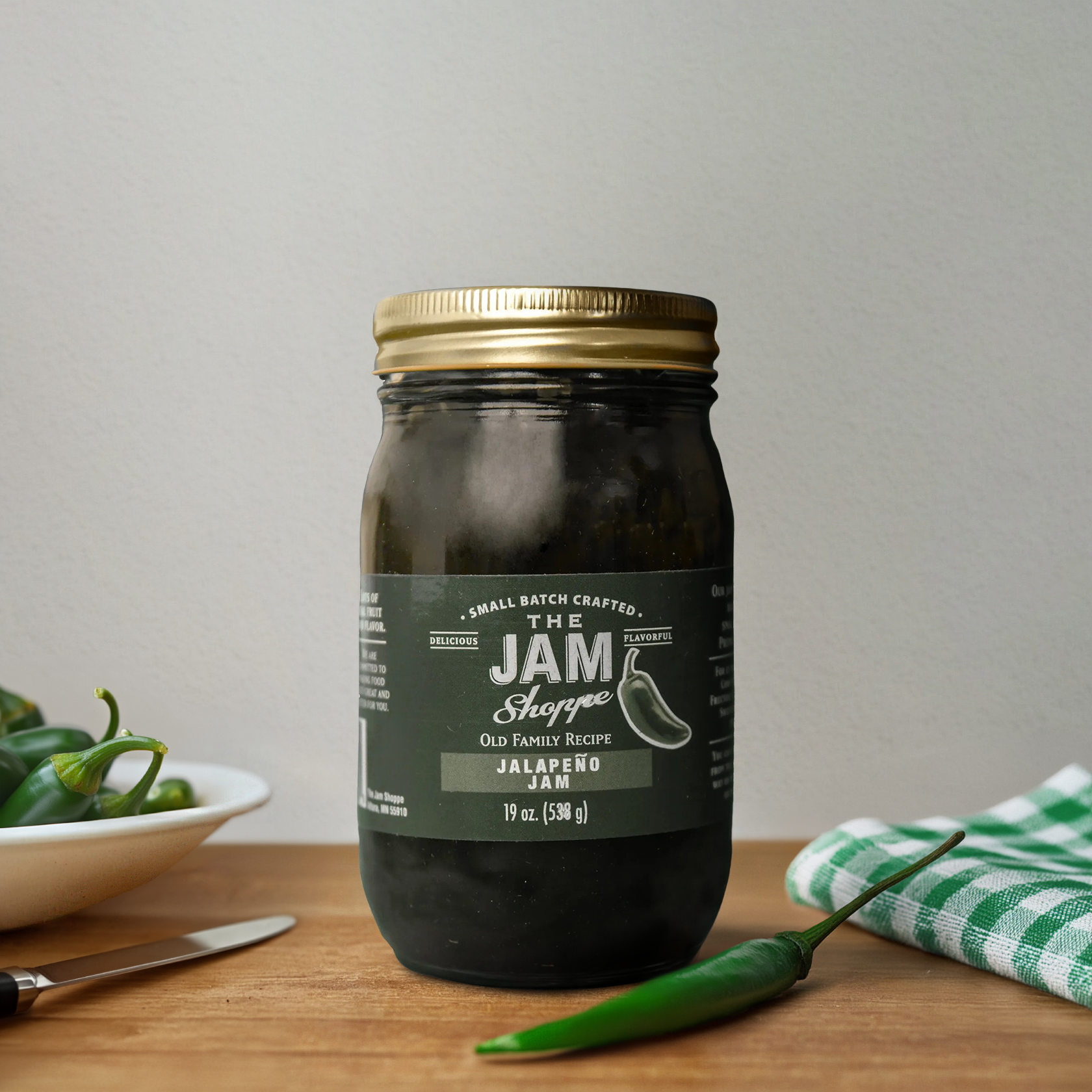 A jar of jam sitting on top of a table.